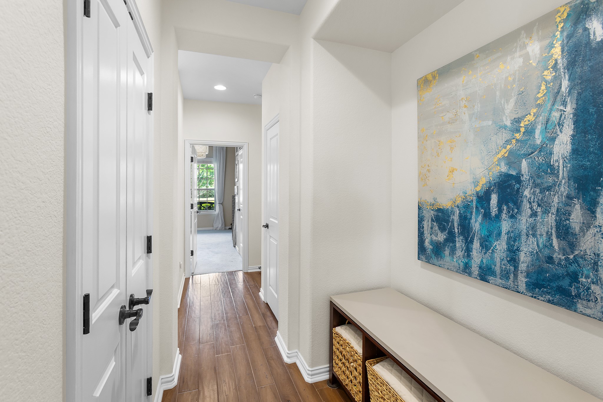 7613 Turnback Ledge Trail Lago Vista, TX 78645 - Photo 21 of 40 a view of a hallway with wooden floor and staircase