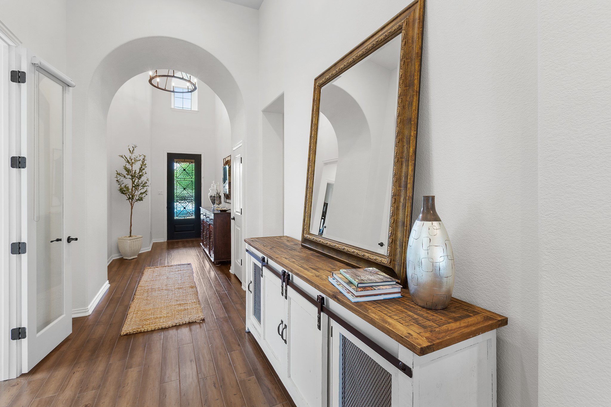 7613 Turnback Ledge Trail Lago Vista, TX 78645 - Photo 22 of 40 Foyer entrance featuring a high ceiling and dark wood finished floors