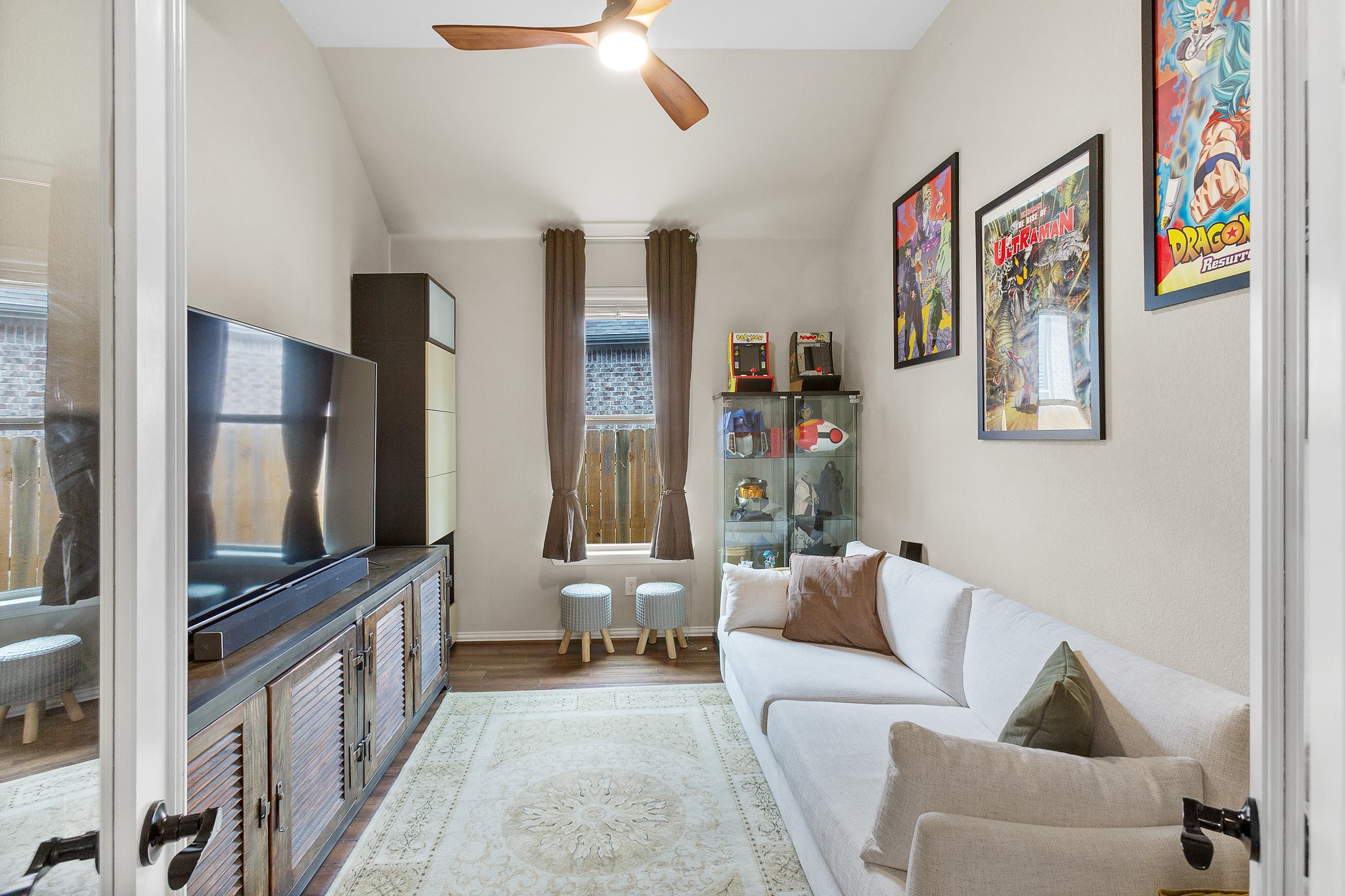 7613 Turnback Ledge Trail Lago Vista, TX 78645 - Photo 23 of 40 a living room with furniture and a flat screen tv