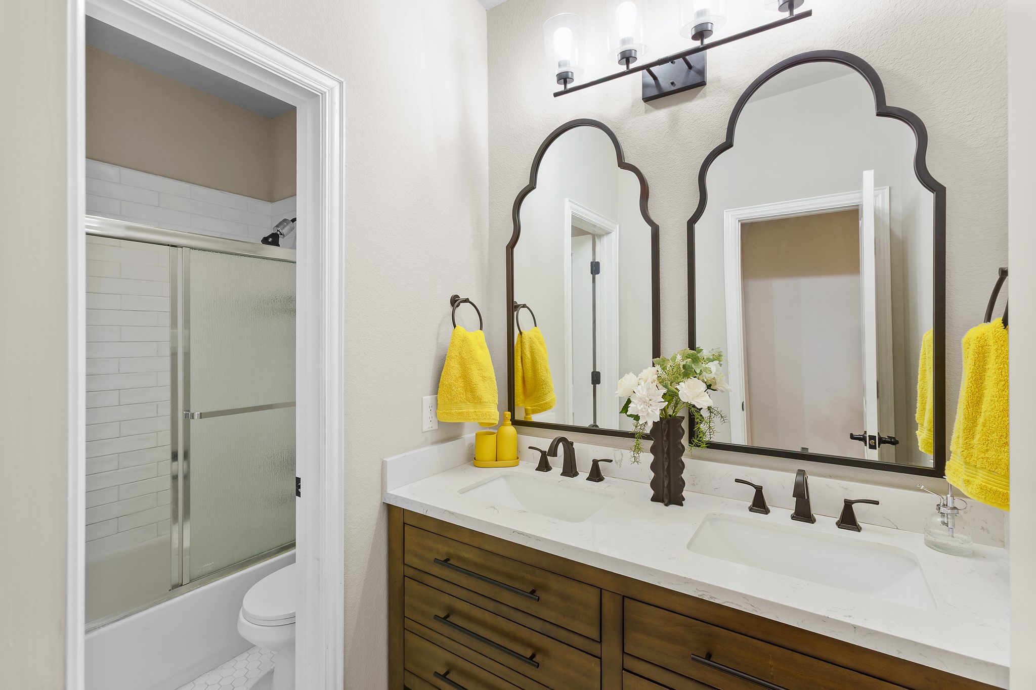 7613 Turnback Ledge Trail Lago Vista, TX 78645 - Photo 24 of 40 a bathroom with a granite countertop sink a toilet and a mirror