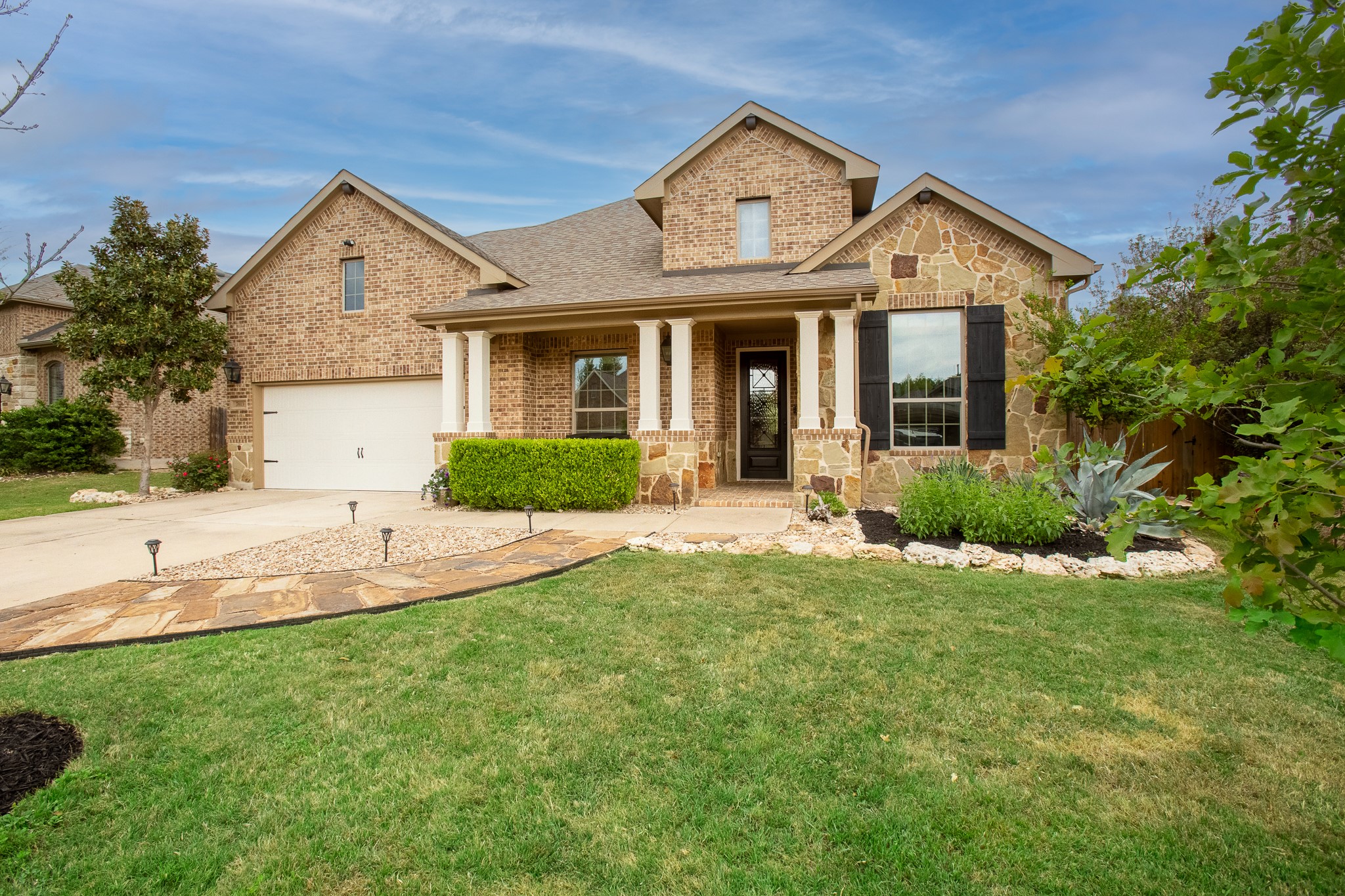 7613 Turnback Ledge Trail Lago Vista, TX 78645 - Photo 28 of 40 a front view of a house with a yard and garage