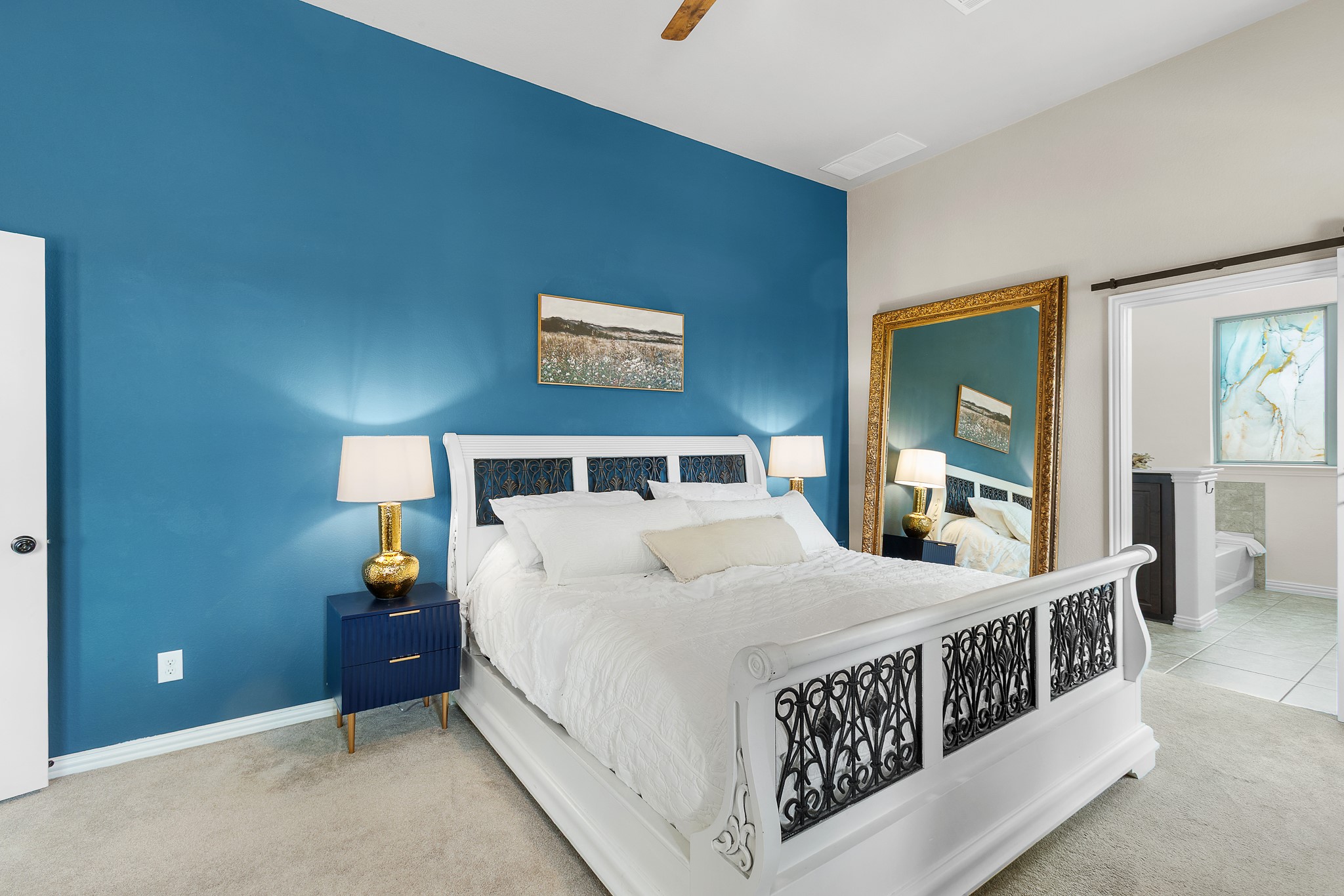 7613 Turnback Ledge Trail Lago Vista, TX 78645 - Photo 31 of 40 a bedroom with a bed a lamp and window