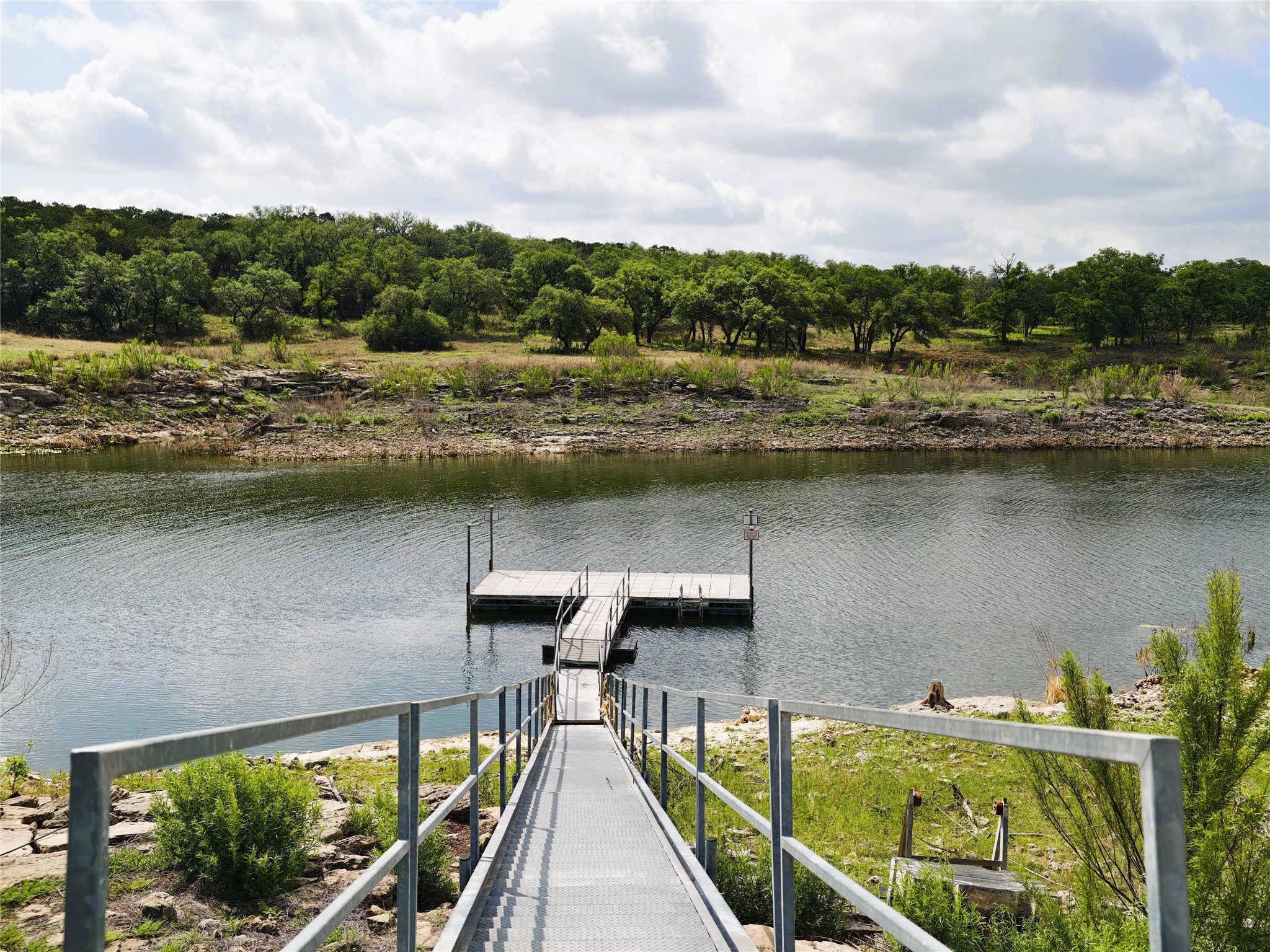 7613 Turnback Ledge Trail Lago Vista, TX 78645 - Photo 38 of 40 a view of a lake with a terrace