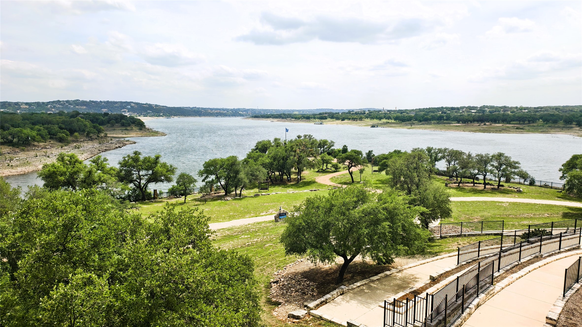 7613 Turnback Ledge Trail Lago Vista, TX 78645 - Photo 40 of 40 a view of a lake with houses in the back