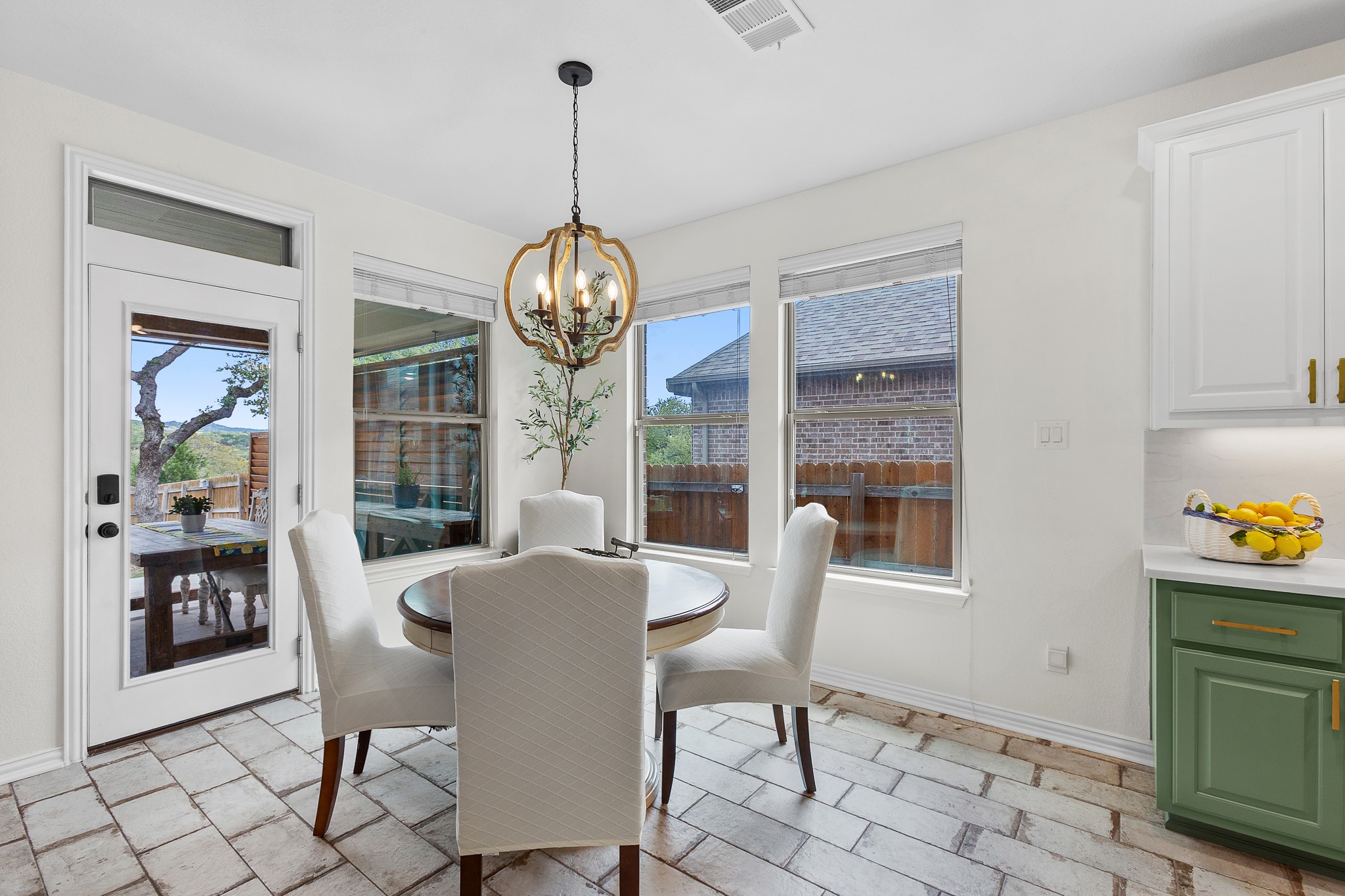 7613 Turnback Ledge Trail Lago Vista, TX 78645 - Photo 8 of 40 a view of a dining room with furniture wooden floor and chandelier