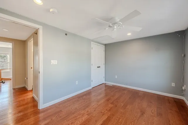 a view of an empty room with wooden floor