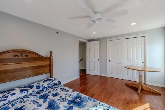 a bedroom with a bed and lamp on dresser