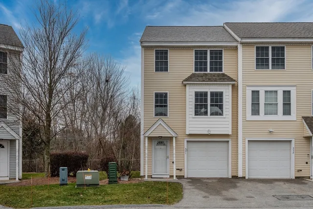 a front view of a house with a yard garage and outdoor seating