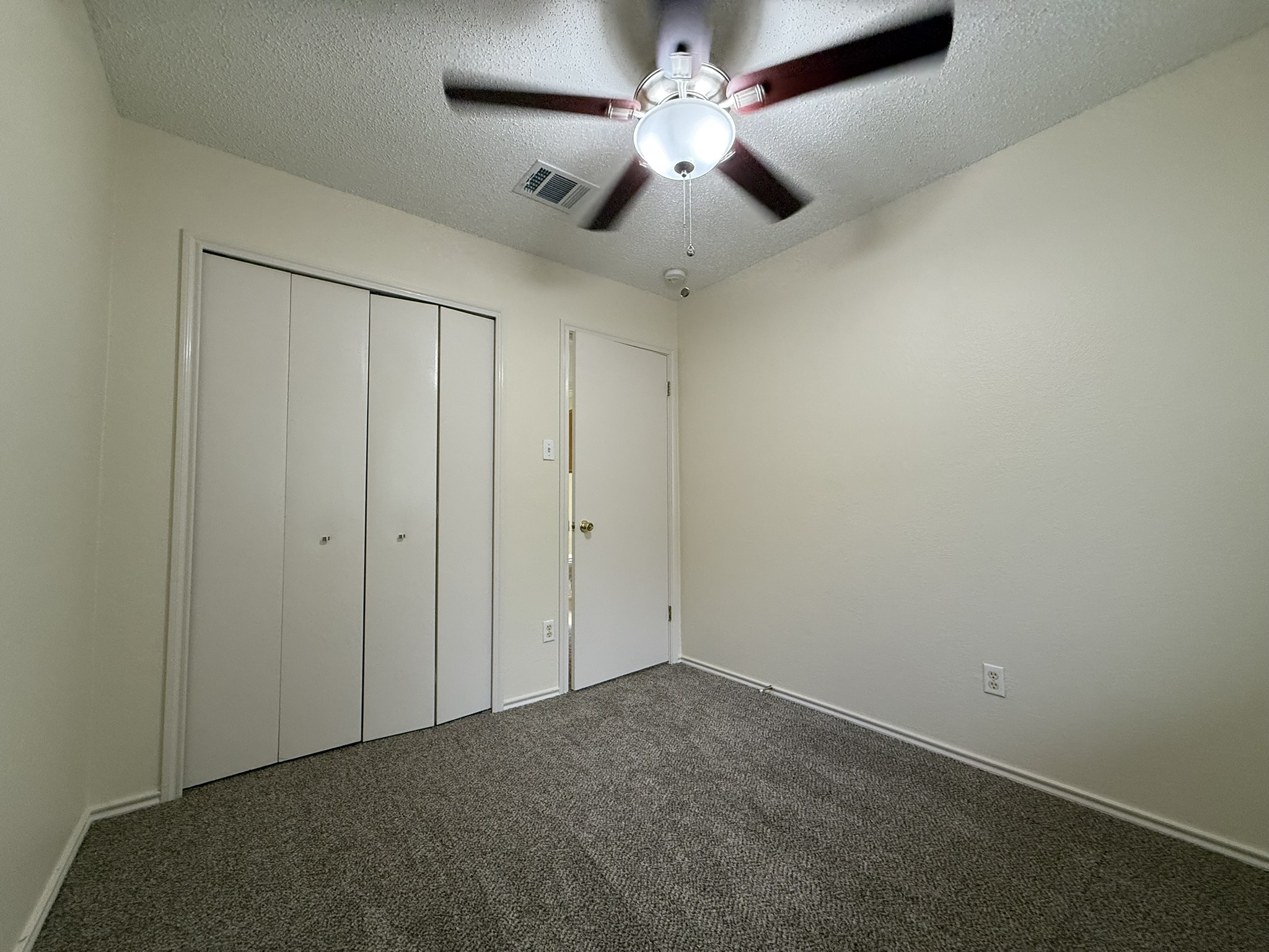 2304 Granberry Drive, Unit B Austin, TX 78745 - Photo 18 of 24 Neutral tone walls with textured ceilings