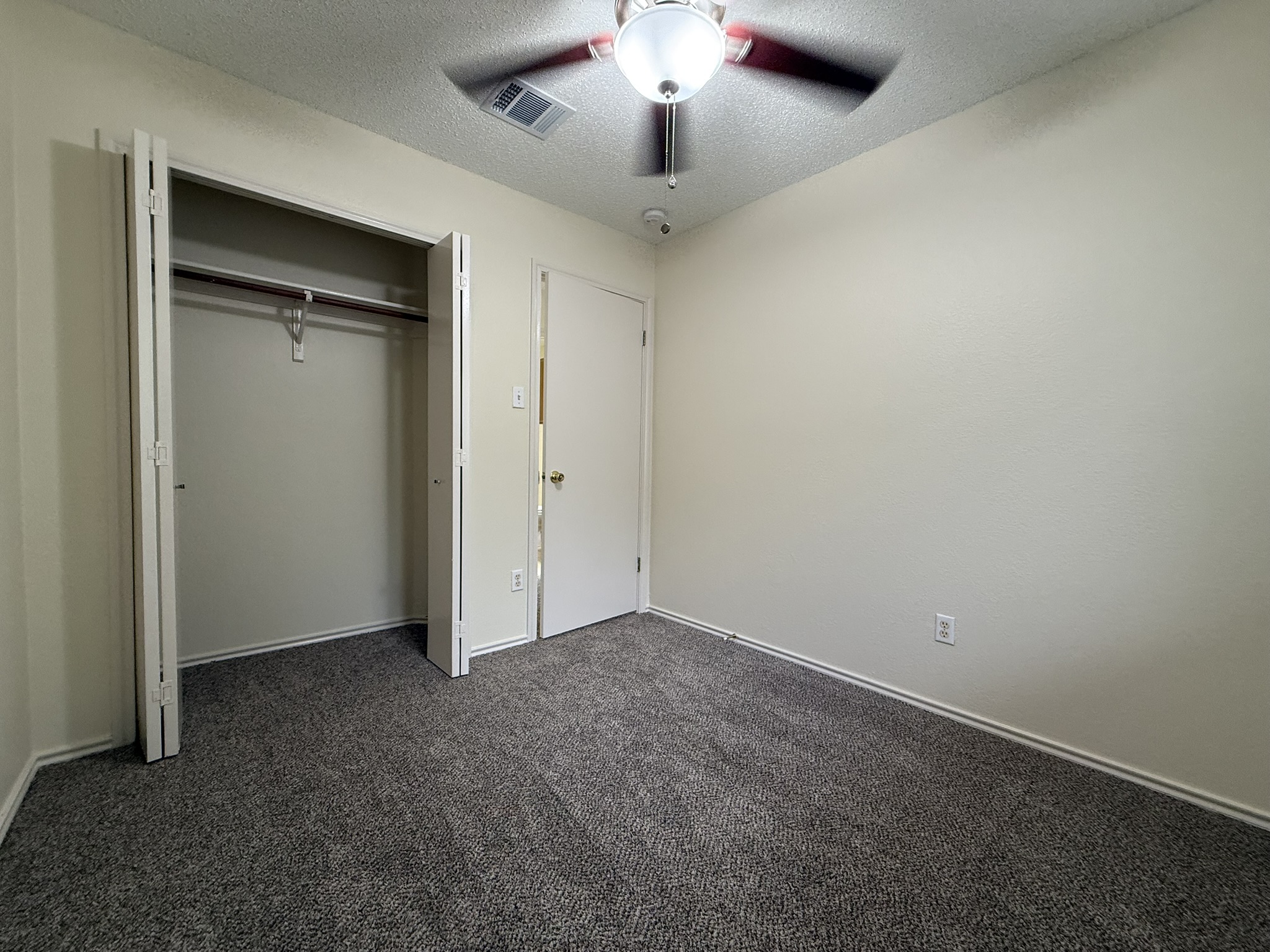 2304 Granberry Drive, Unit B Austin, TX 78745 - Photo 19 of 24 Room featuring neutral wall finishes and dark gray carpeting