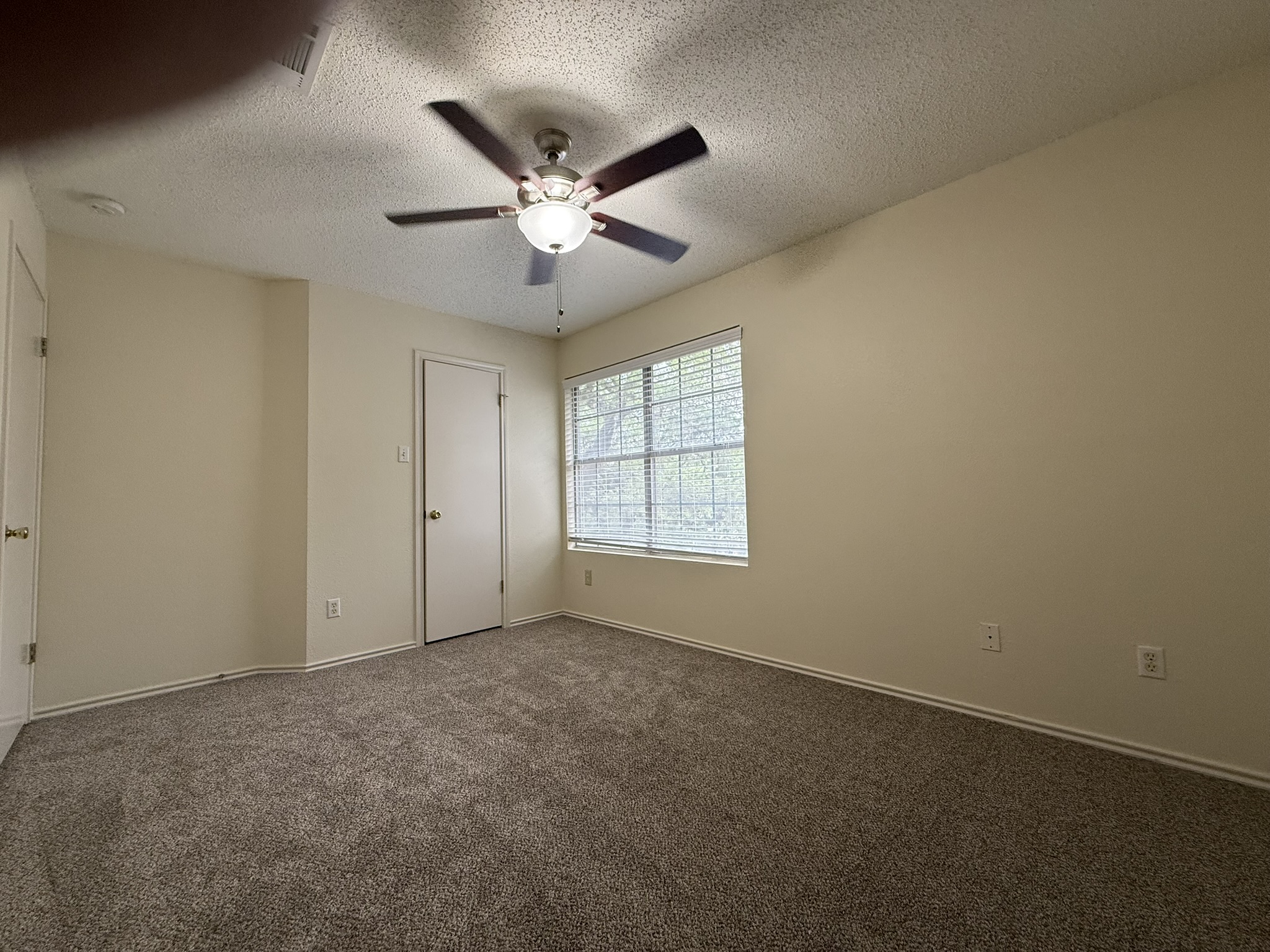 2304 Granberry Drive, Unit B Austin, TX 78745 - Photo 21 of 24 Carpeted room featuring a ceiling fan with integrated lighting, a window with horizontal blinds, and neutral wall tones