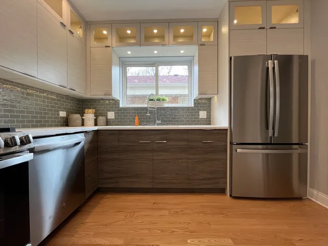a kitchen with a refrigerator and a sink
