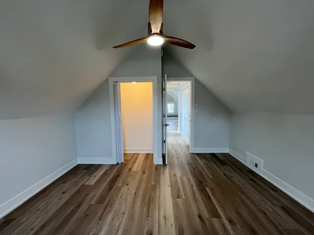a view of room with wooden floor fan and window
