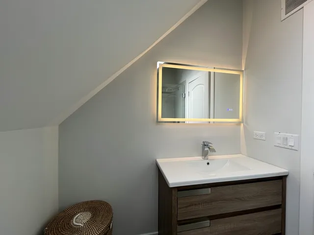 a bathroom with a sink a mirror and vanity