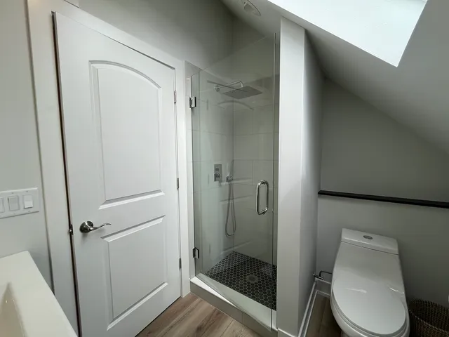 a bathroom with a toilet and a shower