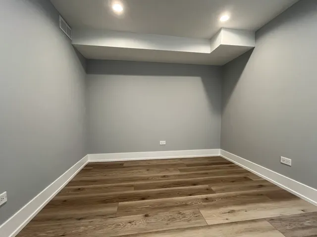 a view of room with stairs and wooden floor