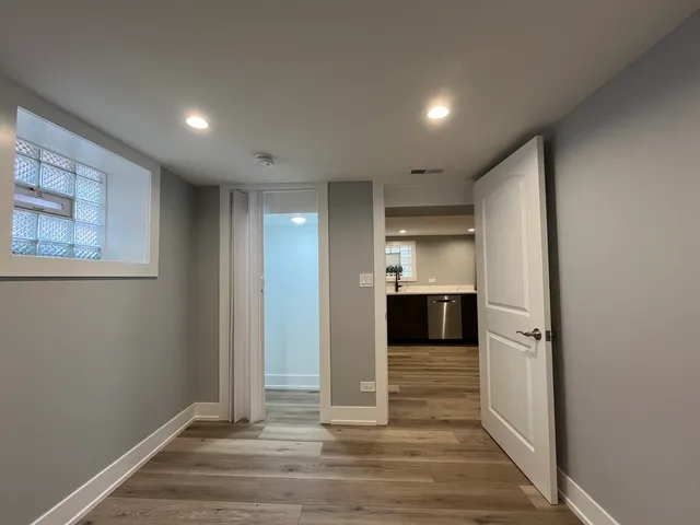 a view of hallway with stairs and wooden floor