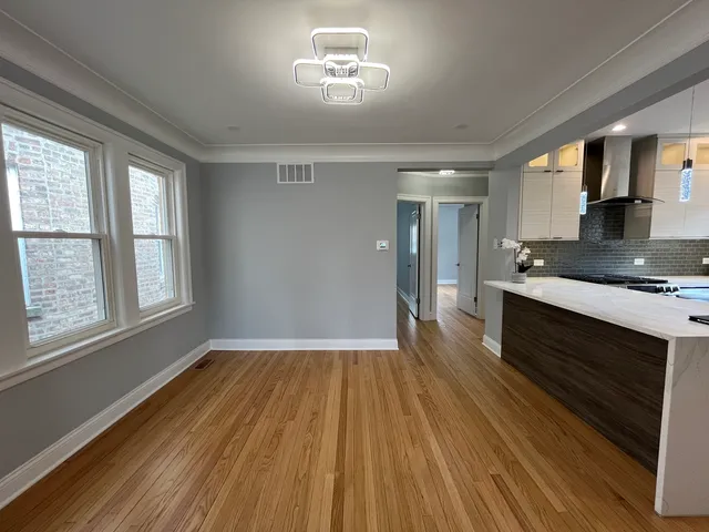 a view of kitchen with sink and wooden floor