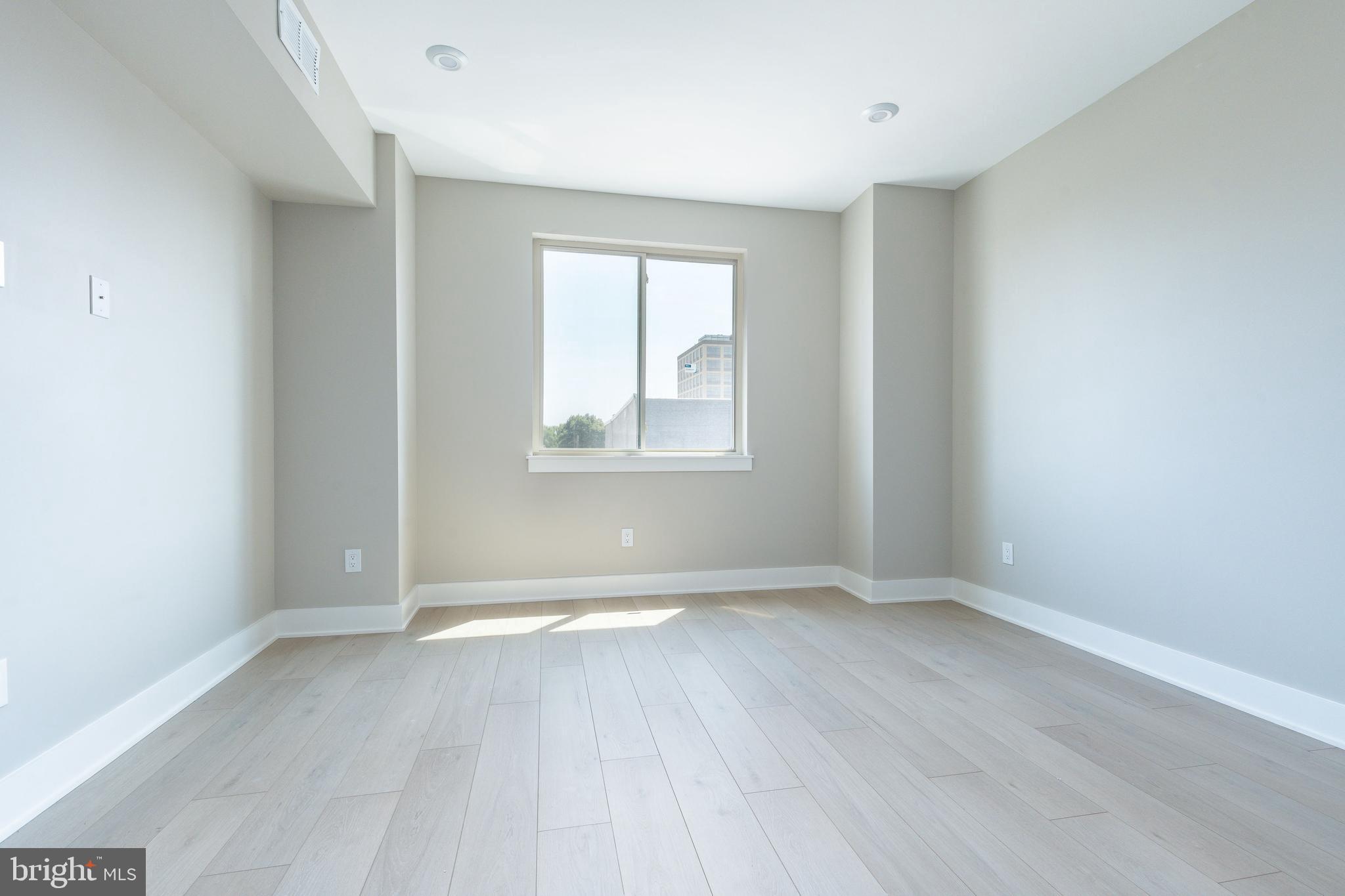 2048 North 3rd Street, Unit 2 Philadelphia, PA 19122 - Photo 12 of 27 an empty room with wooden floor and windows