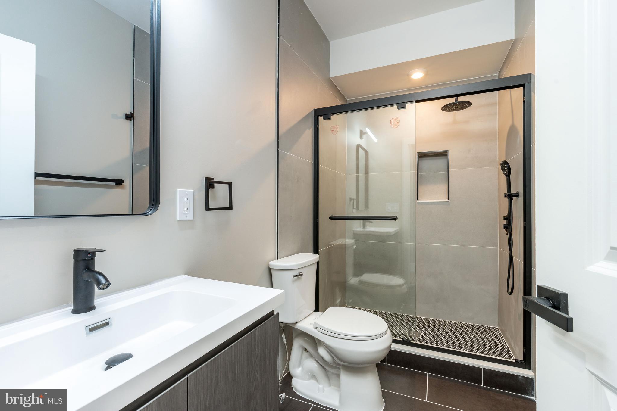 2048 North 3rd Street, Unit 2 Philadelphia, PA 19122 - Photo 15 of 27 a bathroom with a sink a toilet and shower