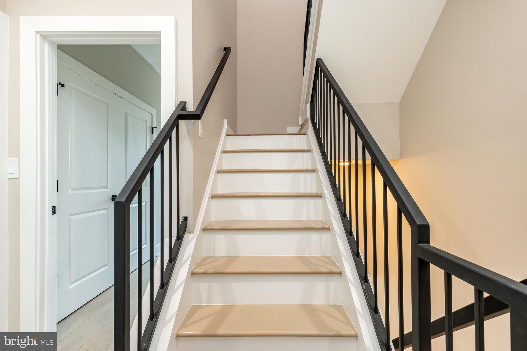 2048 North 3rd Street, Unit 2 Philadelphia, PA 19122 - Photo 17 of 27 a view of staircase with wooden floor and a rug