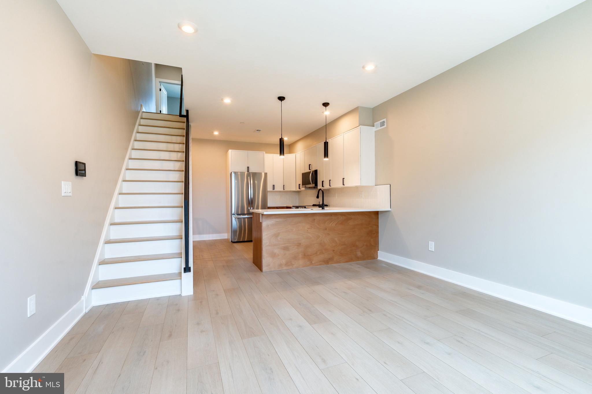 2048 North 3rd Street, Unit 2 Philadelphia, PA 19122 - Photo 4 of 27 a view of kitchen and hall with wooden floor