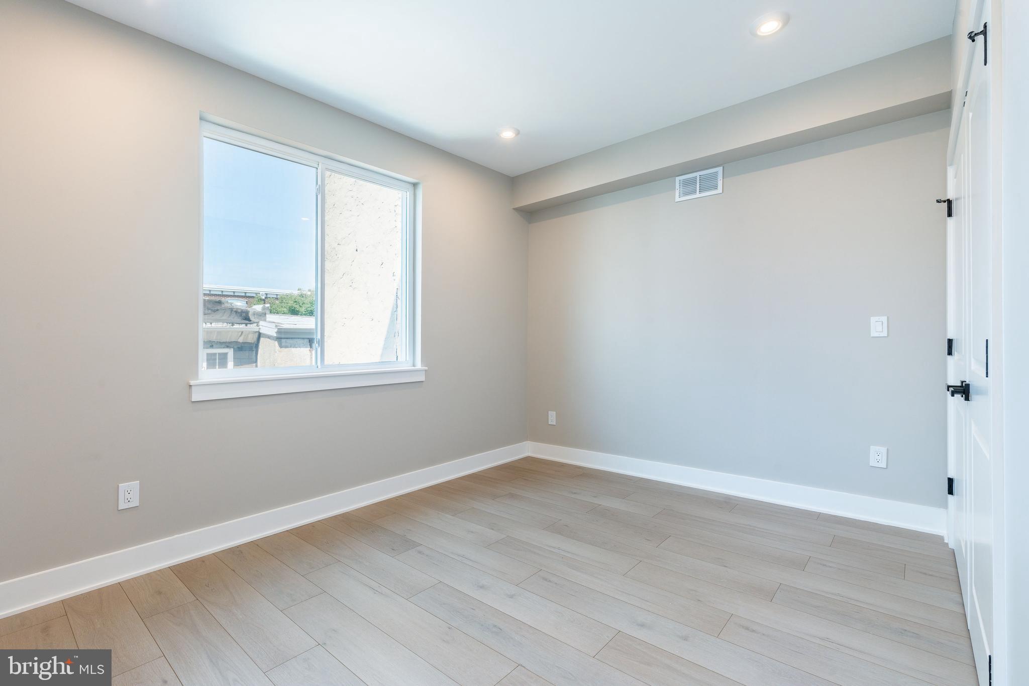 2048 North 3rd Street, Unit 2 Philadelphia, PA 19122 - Photo 8 of 27 a view of an empty room with wooden floor and a window