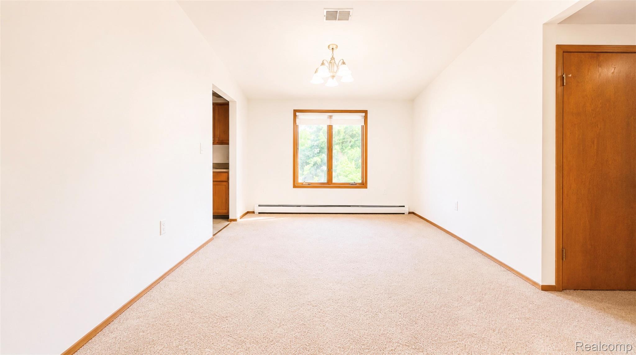 2232 London Bridge Drive, Unit 42 Rochester, MI 48307 - Photo 4 of 20 Neutral-toned wall-to-wall carpeting and white walls create a bright living space