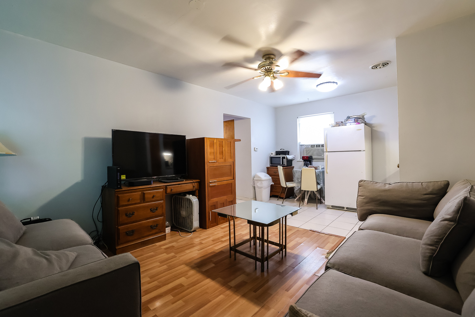 7242 Roosevelt Road Forest Park, IL 60130 - Photo 24 of 36 a living room with furniture and a flat screen tv