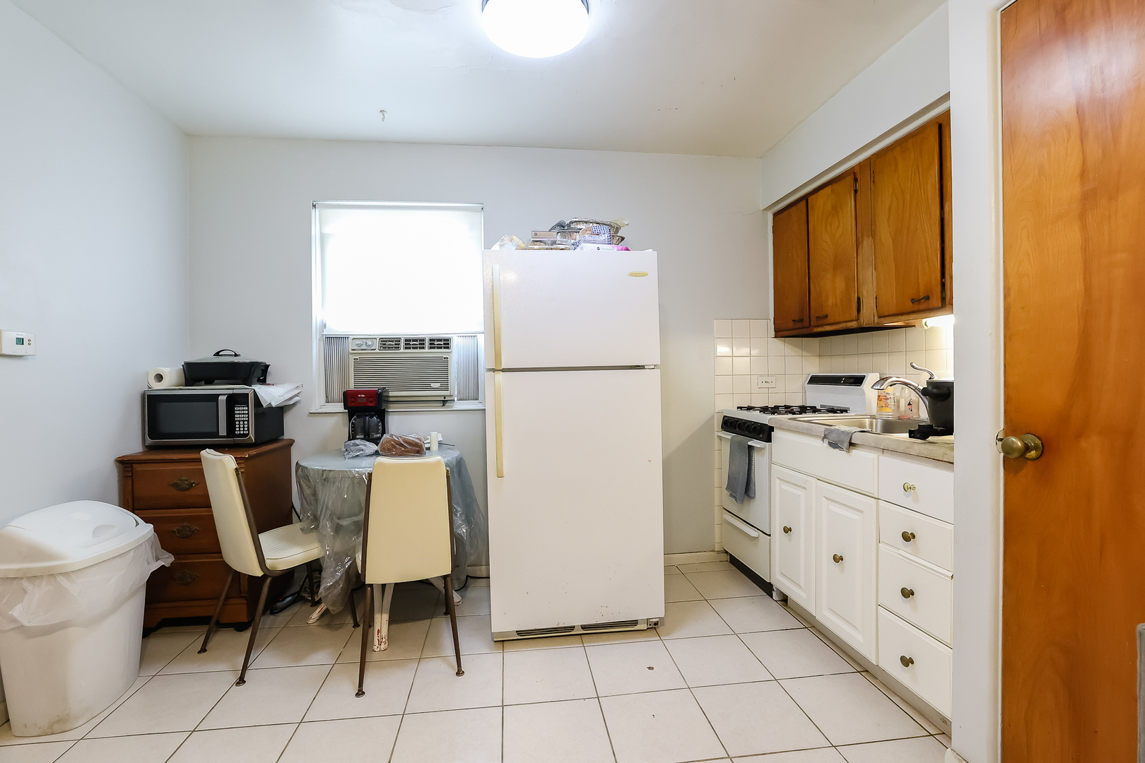 7242 Roosevelt Road Forest Park, IL 60130 - Photo 27 of 36 a kitchen with a refrigerator and table