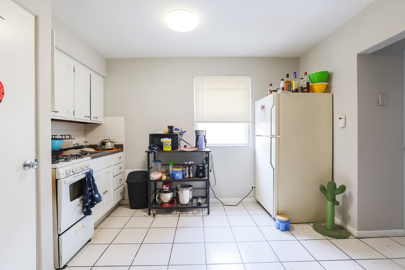 7242 Roosevelt Road Forest Park, IL 60130 - Photo 31 of 36 a kitchen with a refrigerator and a stove top oven