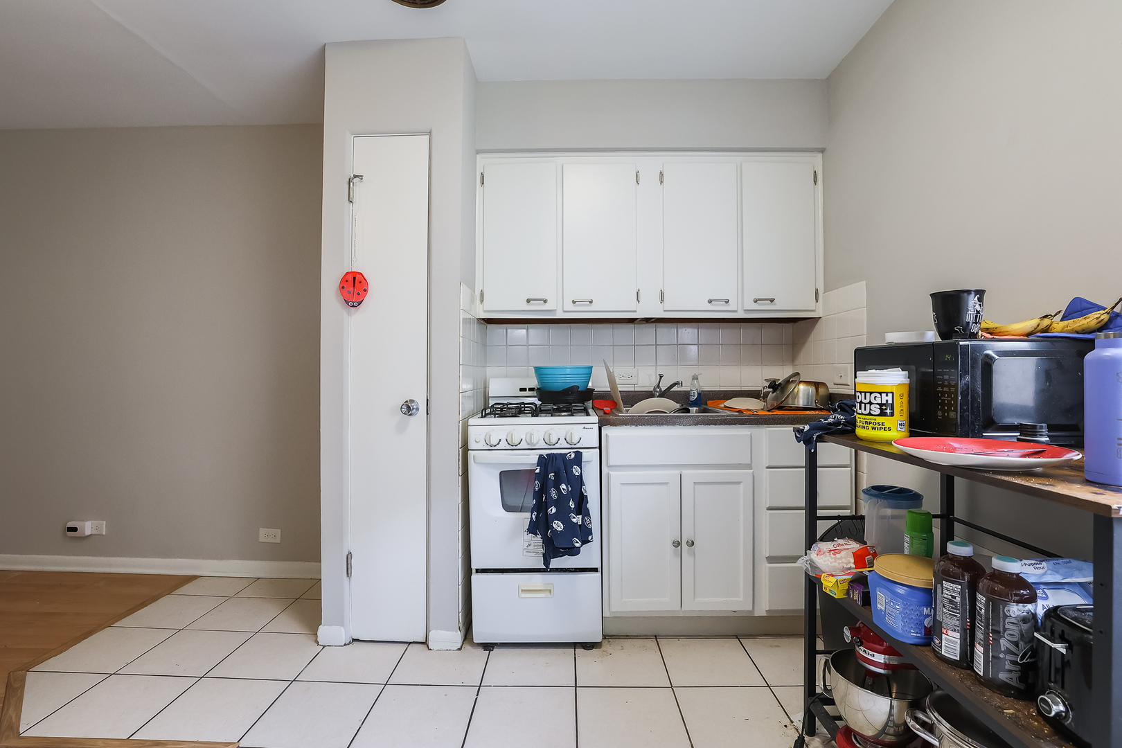 7242 Roosevelt Road Forest Park, IL 60130 - Photo 36 of 36 a kitchen with a refrigerator and white cabinets