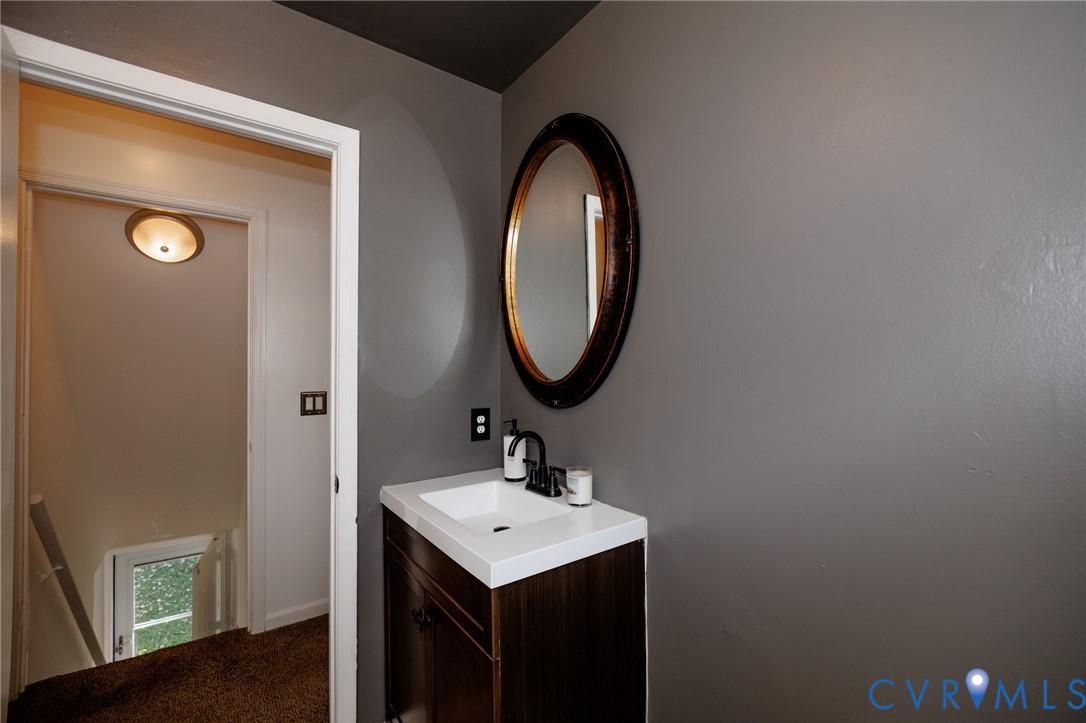 20520 Cox Road Sutherland, VA 23885 - Photo 22 of 31 Modern vanity with an integrated white sink, dark