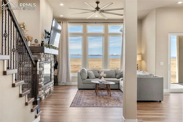 a living room with furniture a flat screen tv and a fireplace