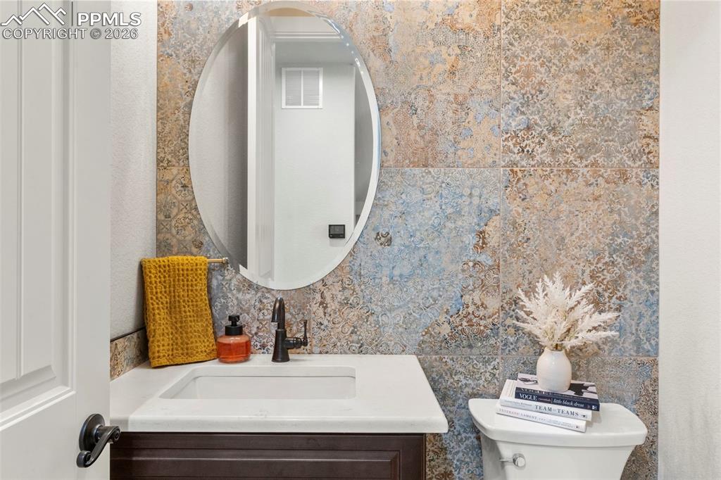 2480 North Log Road Calhan, CO 80808 - Photo 16 of 50 a bathroom with a sink toilet and mirror