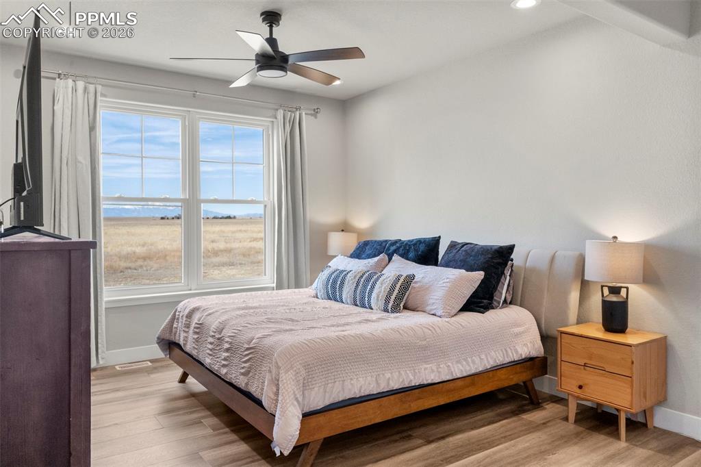 2480 North Log Road Calhan, CO 80808 - Photo 17 of 50 a bedroom with a bed and a chandelier
