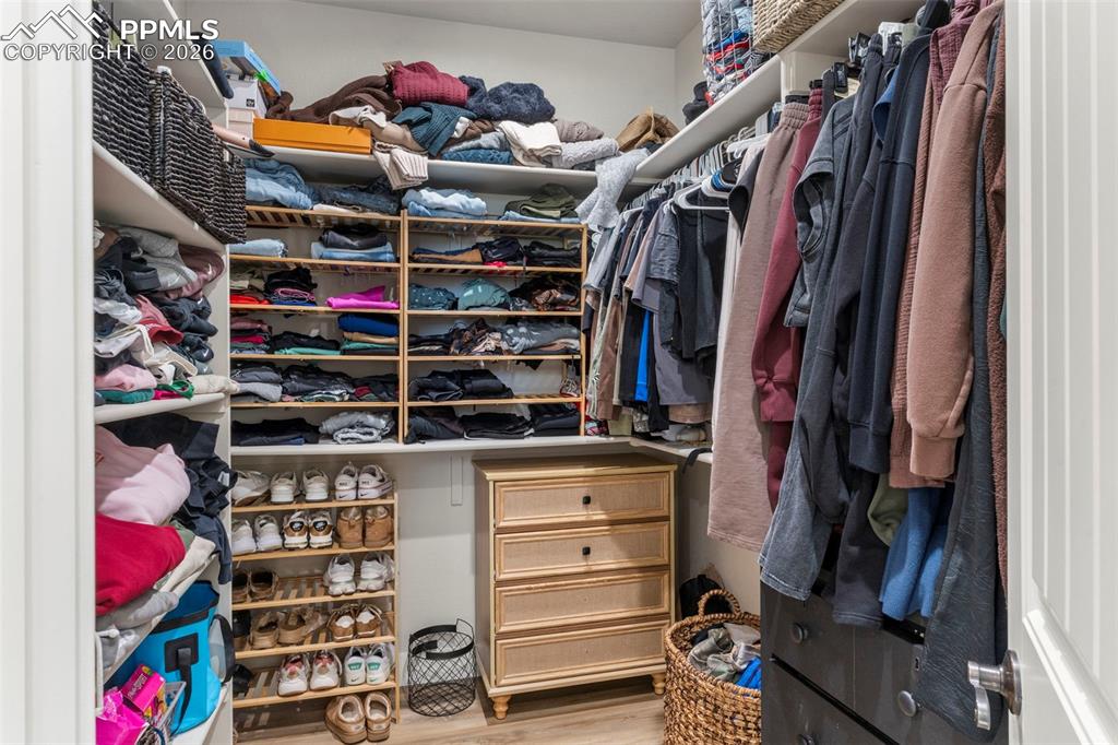 2480 North Log Road Calhan, CO 80808 - Photo 18 of 50 a view of walk in closet with clothes and shoes
