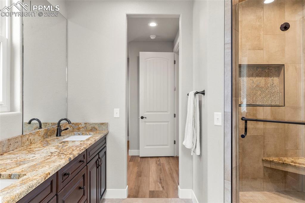 2480 North Log Road Calhan, CO 80808 - Photo 20 of 50 a bathroom with a granite countertop sink and a mirror