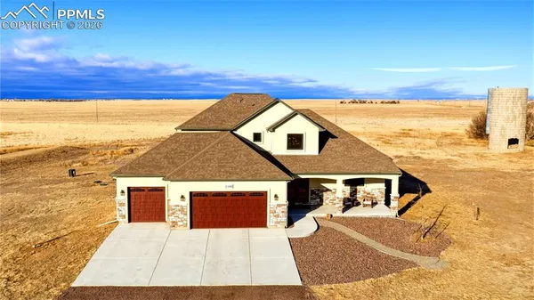 a kitchen with stainless steel appliances kitchen island granite countertop a stove a sink and a refrigerator