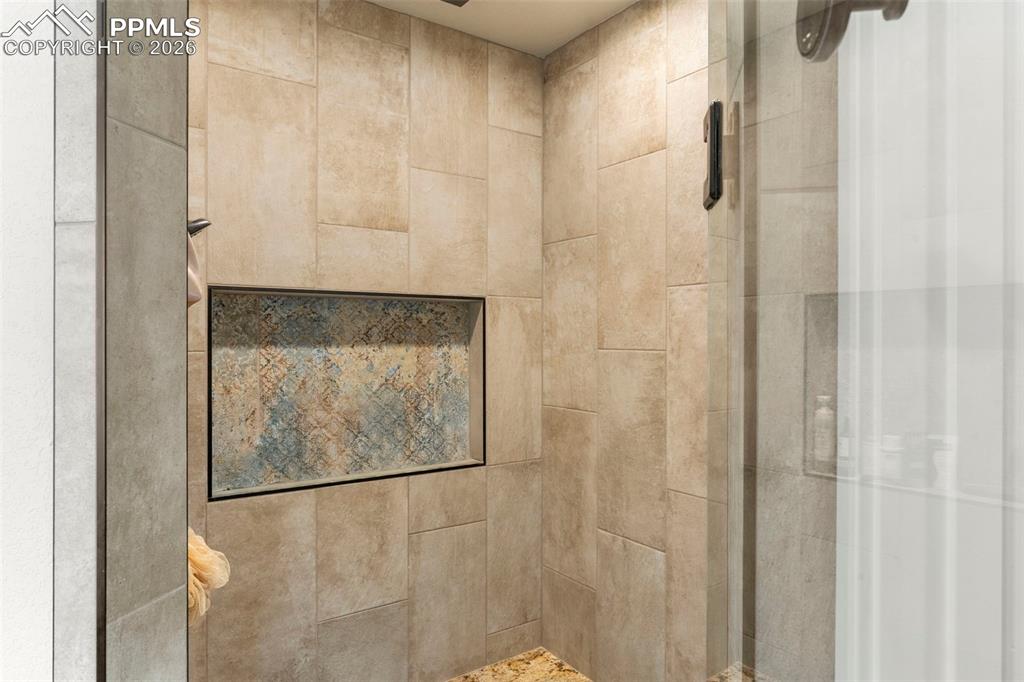 2480 North Log Road Calhan, CO 80808 - Photo 21 of 50 a bathroom with a glass shower door