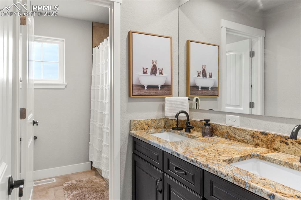 2480 North Log Road Calhan, CO 80808 - Photo 23 of 50 a bathroom with a sink and a mirror