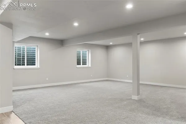 a bathroom with double vanity and a mirror