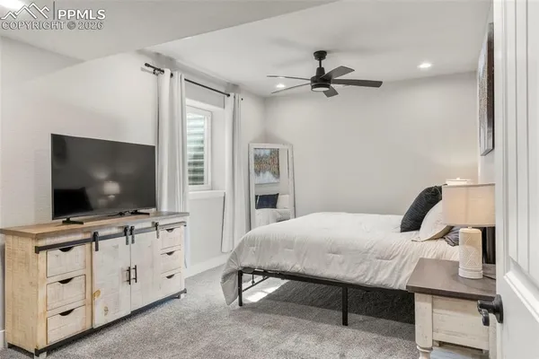 a bathroom with a granite countertop sink a toilet and a mirror