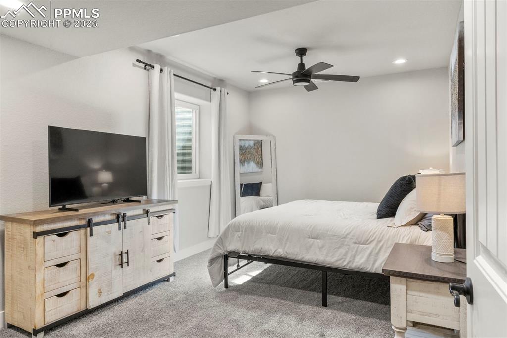 2480 North Log Road Calhan, CO 80808 - Photo 29 of 50 a bedroom with furniture and flat screen tv