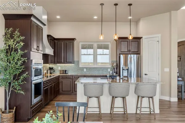 a kitchen with granite countertop a stove a sink and a cabinets