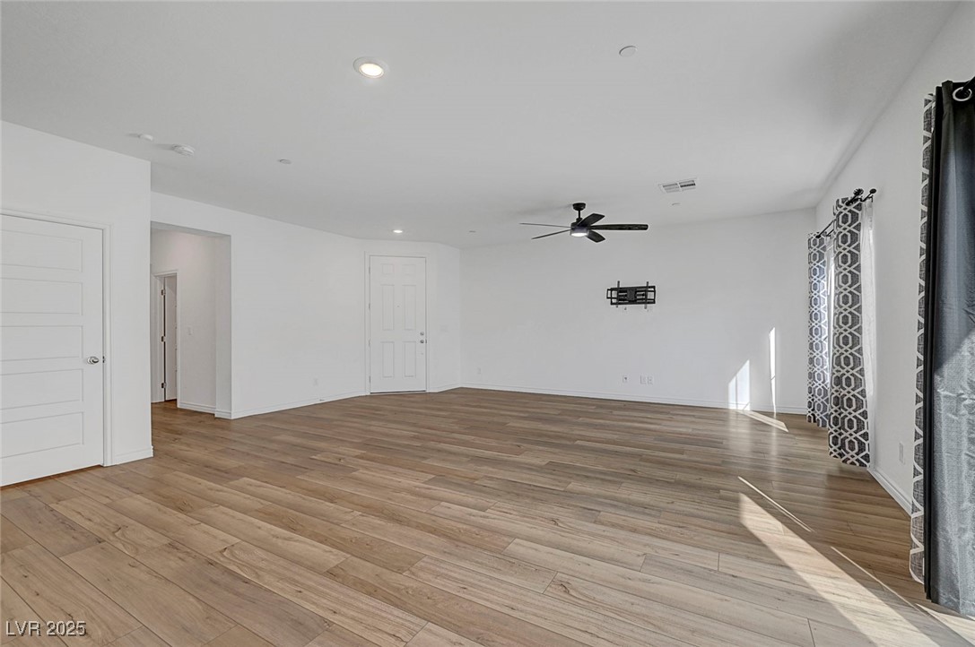 7204 North Decatur Boulevard North Las Vegas, NV 89084 - Photo 12 of 55 Unfurnished living room with light wood finished floors, baseboards, visible vents, ceiling fan, and recessed lighting