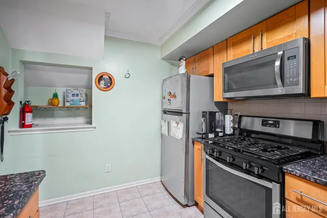 a kitchen with stainless steel appliances granite countertop a stove and a refrigerator