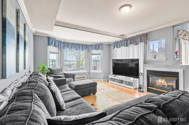 a living room with furniture fireplace and flat screen tv