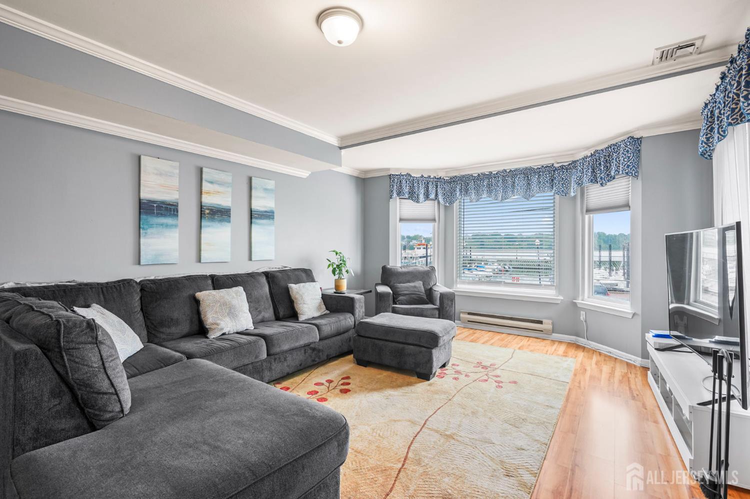 265 Front Street Perth Amboy, NJ 08861 - Photo 14 of 38 a living room with furniture and a flat screen tv