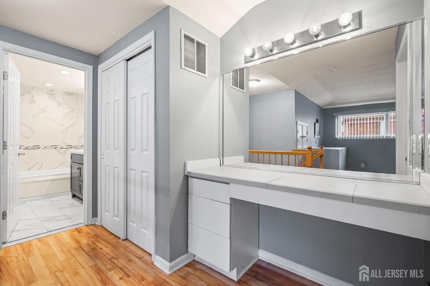 265 Front Street Perth Amboy, NJ 08861 - Photo 32 of 38 a spacious bathroom with a granite countertop sink and a mirror